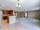 Spacious living room features a ceiling fan and transitions to the kitchen area at 12121 Tree Haven Ave, Gibsonton, FL 33534