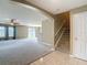 Spacious living room featuring neutral paint, and staircase access at 12121 Tree Haven Ave, Gibsonton, FL 33534