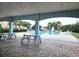 Community pool with shaded picnic area and plentiful lounge chairs offer the perfect spot for relaxation at 12121 Tree Haven Ave, Gibsonton, FL 33534
