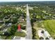 An aerial shot of the property location, close to a baseball field, on a quiet street, and surrounded by trees at 12277 Spring Hill Dr, Spring Hill, FL 34609