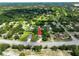 Aerial view of home showcasing landscaping in a lush neighborhood with mature trees at 12277 Spring Hill Dr, Spring Hill, FL 34609