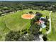 Aerial view of baseball field, playground, and pool offer recreational activities at 12277 Spring Hill Dr, Spring Hill, FL 34609