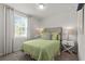 Bright bedroom featuring a queen-sized bed, large window with curtains and bedside tables with lamps at 12277 Spring Hill Dr, Spring Hill, FL 34609