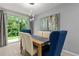 Elegant dining area with modern lighting and a view to the backyard, perfect for Gathering gatherings at 12277 Spring Hill Dr, Spring Hill, FL 34609