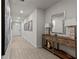A long hallway with wood floors, recessed lights, neutral paint and tasteful decorations at 12277 Spring Hill Dr, Spring Hill, FL 34609