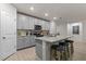 Open kitchen showcases gray cabinets, stainless steel appliances, a large granite island, and seating at 12277 Spring Hill Dr, Spring Hill, FL 34609
