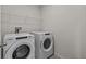 Laundry room featuring modern washer and dryer units with wire shelving at 12277 Spring Hill Dr, Spring Hill, FL 34609