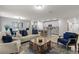Spacious living area featuring an open floor plan to the kitchen and dining space, with modern decor at 12277 Spring Hill Dr, Spring Hill, FL 34609