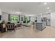 A spacious living room and kitchen combo with gray walls, wood floors, and ample sunlight at 12277 Spring Hill Dr, Spring Hill, FL 34609