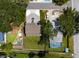 Overhead view of the property highlighting the roof, driveway, and enclosed pool area at 132 Pennsylvania Ave, Palm Harbor, FL 34683