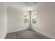 Carpeted bedroom illuminated by natural light from two windows, creating a bright and airy space at 132 Pennsylvania Ave, Palm Harbor, FL 34683