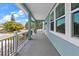 Inviting front porch with ample space, featuring views of the neighborhood and stylish railings at 132 Pennsylvania Ave, Palm Harbor, FL 34683