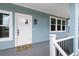 Inviting covered front porch featuring a new door and fresh paint at 132 Pennsylvania Ave, Palm Harbor, FL 34683