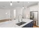 Modern kitchen featuring an island sink, new stainless steel refrigerator, and hardwood flooring at 132 Pennsylvania Ave, Palm Harbor, FL 34683