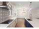 Modern kitchen and dining room featuring stainless steel appliances and an island at 132 Pennsylvania Ave, Palm Harbor, FL 34683