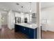 Gourmet kitchen with an island, custom backsplash, stainless steel appliances, and wood-look flooring at 132 Pennsylvania Ave, Palm Harbor, FL 34683