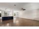 Spacious living room flows into the kitchen, featuring hardwood floors and stylish ceiling fans at 132 Pennsylvania Ave, Palm Harbor, FL 34683