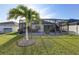 Enclosed patio and yard with palm tree in a well-maintained backyard at 1332 Ocean Spray Dr, Ruskin, FL 33570