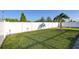 Large fenced backyard with lush green lawn and tropical landscaping at 1332 Ocean Spray Dr, Ruskin, FL 33570