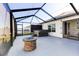 Spacious screened-in patio with hot tub and fire pit, ideal for outdoor gatherings at 1332 Ocean Spray Dr, Ruskin, FL 33570