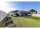 Lush backyard with screened patio, garden beds, and white fence surround at 1332 Ocean Spray Dr, Ruskin, FL 33570