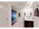 Bathroom with double sinks, a large mirror, and a walk-in shower at 1332 Ocean Spray Dr, Ruskin, FL 33570