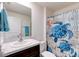 Bright bathroom featuring a single sink, modern vanity, and a decorative turtle-themed shower curtain at 1332 Ocean Spray Dr, Ruskin, FL 33570