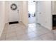 Inviting entryway with neutral tile flooring, a white front door, and decorative wreath at 1332 Ocean Spray Dr, Ruskin, FL 33570
