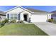 Charming single-story home with a well-manicured lawn and a two-car garage at 1332 Ocean Spray Dr, Ruskin, FL 33570