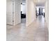 Bright hallway with modern tiled floors leading to multiple rooms at 1332 Ocean Spray Dr, Ruskin, FL 33570