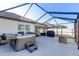 Enclosed patio with hot tub, fire pit, and spacious seating area at 1332 Ocean Spray Dr, Ruskin, FL 33570