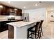 Modern kitchen with granite countertops, stainless steel appliances, dark cabinetry, and an island with bar seating at 1332 Ocean Spray Dr, Ruskin, FL 33570