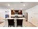 Modern kitchen with stainless steel appliances, dark cabinetry, and a granite island with bar stools at 1332 Ocean Spray Dr, Ruskin, FL 33570