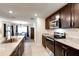 Spacious kitchen featuring dark wood cabinets, stainless steel appliances, and a modern countertop at 1332 Ocean Spray Dr, Ruskin, FL 33570