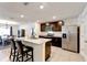 Open-concept kitchen with stainless steel appliances, a granite island with bar stools, and dark cabinetry at 1332 Ocean Spray Dr, Ruskin, FL 33570