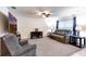 Cozy living room with carpeted floors, plush seating, a large television, and a ceiling fan at 1332 Ocean Spray Dr, Ruskin, FL 33570