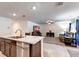 Open concept view of a kitchen island, living room, and ceiling fan, providing an inviting atmosphere at 1332 Ocean Spray Dr, Ruskin, FL 33570