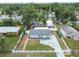 A home with mature trees, a fenced yard, and a driveway at 1510 W Powhatan Ave, Tampa, FL 33603