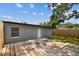 Private fenced backyard with wood deck and mature trees at 1510 W Powhatan Ave, Tampa, FL 33603