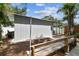 Backyard view with a bench, firepit, shade tree and open carport at 1510 W Powhatan Ave, Tampa, FL 33603