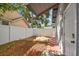 This home's backyard features a wooden deck, white fence and a brick and concrete walkway at 1510 W Powhatan Ave, Tampa, FL 33603