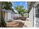 Cozy backyard featuring a fire pit, wooden bench, and lush landscaping at 1510 W Powhatan Ave, Tampa, FL 33603