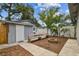 Inviting backyard with fire pit, bench seating, and privacy fence at 1510 W Powhatan Ave, Tampa, FL 33603