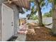 This home's backyard features a mature tree, hammock, gray exterior and a brick and concrete walkway at 1510 W Powhatan Ave, Tampa, FL 33603