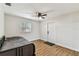 Bright bedroom featuring a ceiling fan, window, and wood-look flooring at 1510 W Powhatan Ave, Tampa, FL 33603