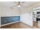 Cozy bedroom with updated flooring, ceiling fan, and view to the kitchen at 1510 W Powhatan Ave, Tampa, FL 33603