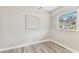 A quaint bedroom featuring wood-look flooring and two windows with blinds at 1510 W Powhatan Ave, Tampa, FL 33603