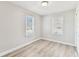 Bright bedroom featuring wood-look flooring and two windows at 1510 W Powhatan Ave, Tampa, FL 33603