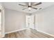 Bedroom with wood-look flooring, ceiling fan and closet, creating a cozy space at 1510 W Powhatan Ave, Tampa, FL 33603