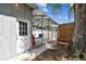 Carport next to a white door, a red hose is attached to the building at 1510 W Powhatan Ave, Tampa, FL 33603